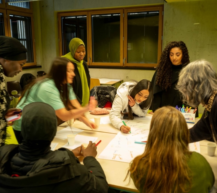 Jeunes et adultes écrivant autour d'une grande affiche « Culture » lors de l'atelier OUR CULTURE en France